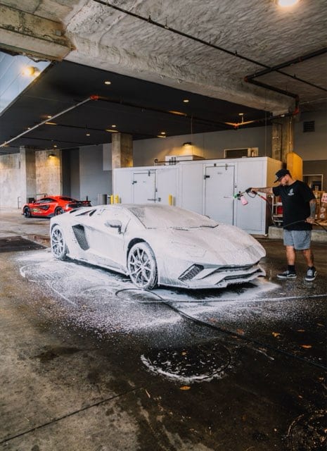 Lamborghini Aventador buried in snow foam at the rally